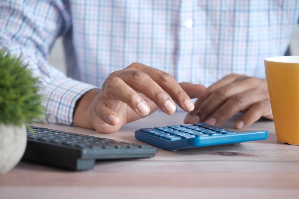 man calculating numbers after learning who pays closing costs in florida